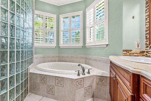 bathroom with vanity, tile patterned flooring, a relaxing tiled tub, and crown molding