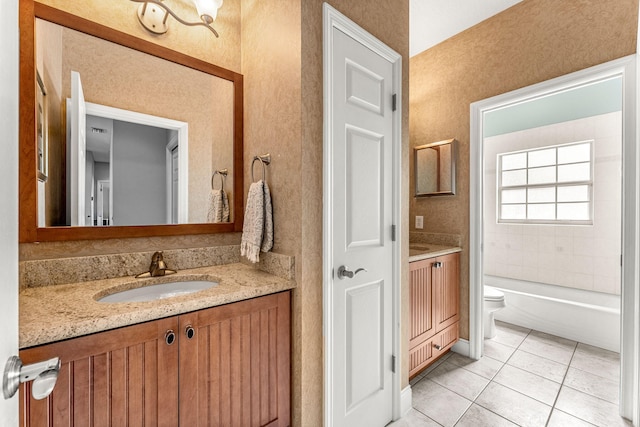 full bathroom with toilet, vanity, tile patterned flooring, and tiled shower / bath