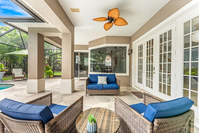 view of patio / terrace with ceiling fan, a lanai, french doors, and an outdoor hangout area