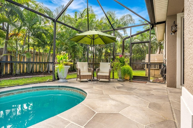 view of pool with a lanai and a patio