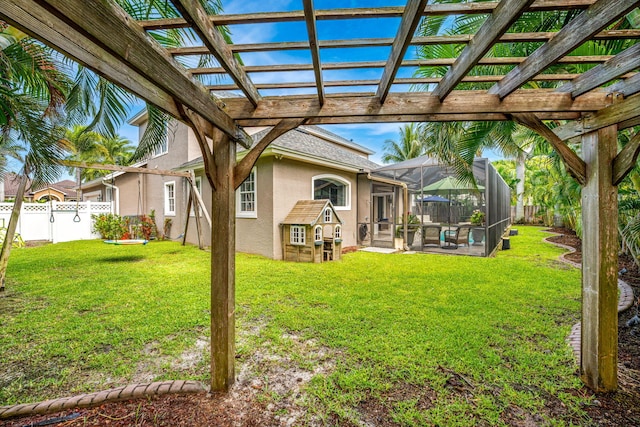 view of yard with a lanai and a pergola