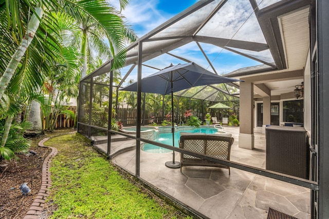 view of pool with a lanai and a patio area