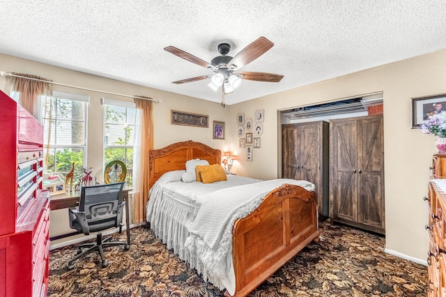 bedroom with ceiling fan and a textured ceiling