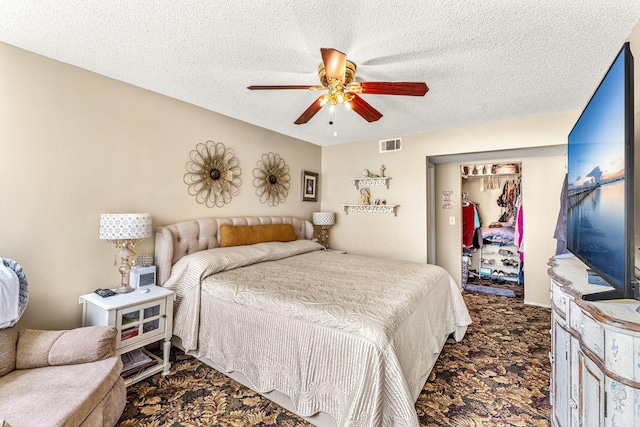 bedroom featuring a closet, ceiling fan, and a textured ceiling