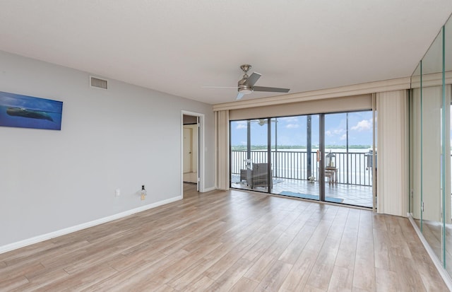 unfurnished room featuring ceiling fan and light hardwood / wood-style flooring