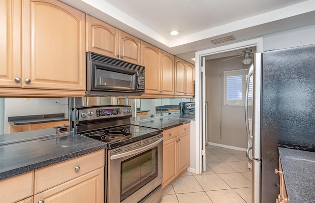 kitchen with stainless steel appliances, light brown cabinets, light tile patterned floors, and ceiling fan