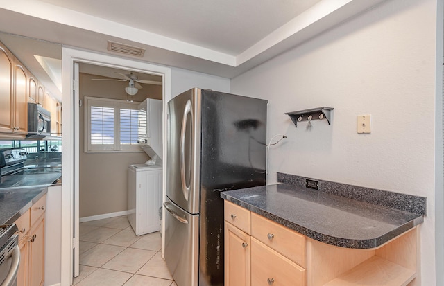 kitchen with light tile patterned flooring, stainless steel appliances, light brown cabinetry, and ceiling fan