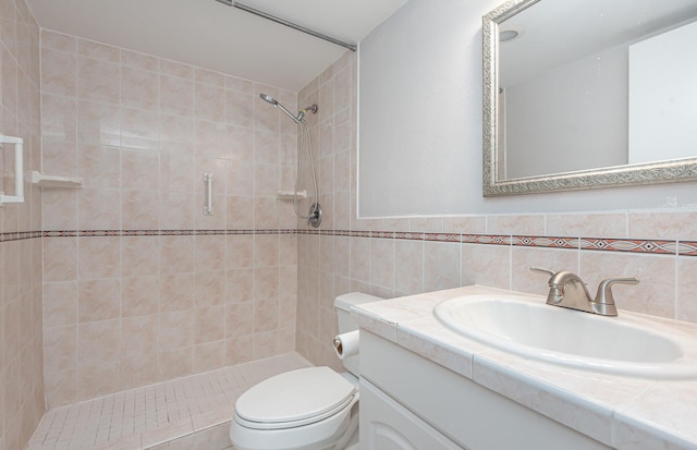 bathroom featuring tile walls, tiled shower, decorative backsplash, toilet, and vanity