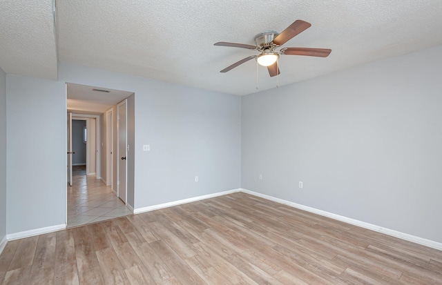 unfurnished room with light hardwood / wood-style flooring, a textured ceiling, and ceiling fan