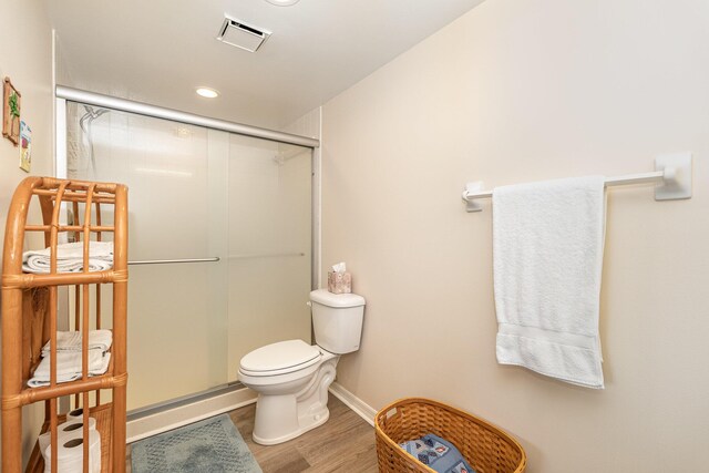1860 N Atlantic Ave Unit 604, Cocoa Beach, FL 32931 - full bath with toilet, a stall shower, visible vents, baseboards, and wood finished floors