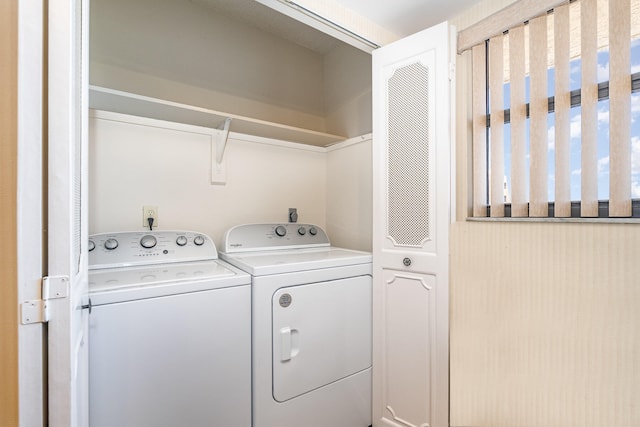 washroom with washing machine and clothes dryer