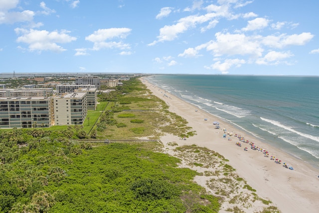 drone / aerial view with a water view and a beach view