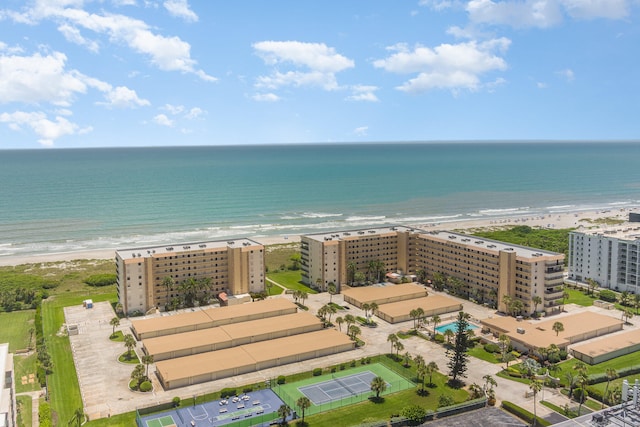 drone / aerial view with a water view and a beach view