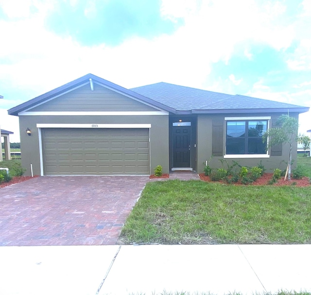 view of front of house with a garage and a front yard