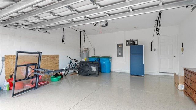 garage featuring a garage door opener, electric panel, and water heater