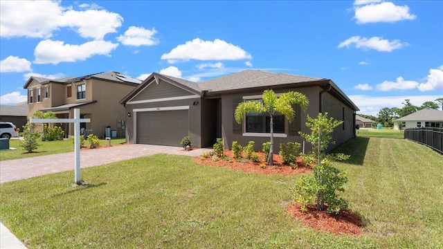 view of front of home with a garage and a front lawn