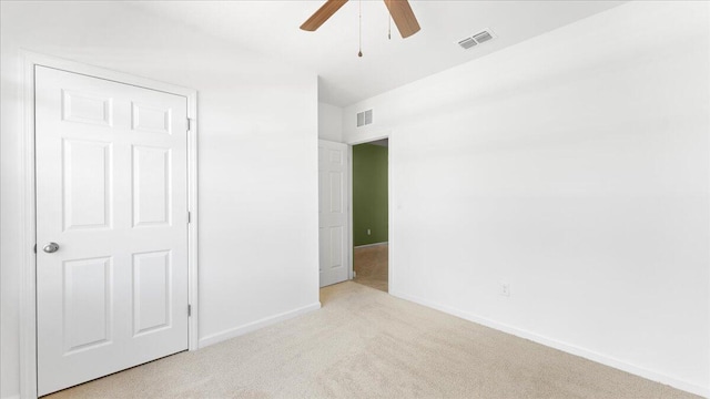 unfurnished bedroom with ceiling fan and light carpet