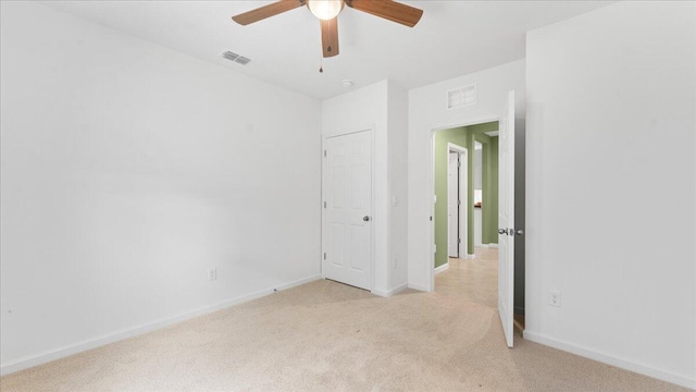 spare room with light carpet and ceiling fan