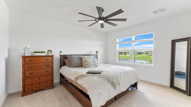 bedroom featuring light colored carpet and ceiling fan