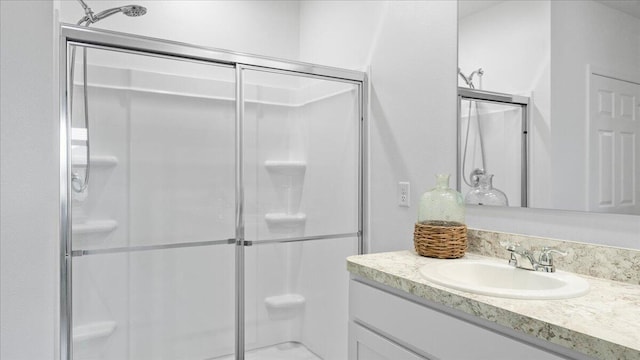 bathroom featuring vanity and an enclosed shower