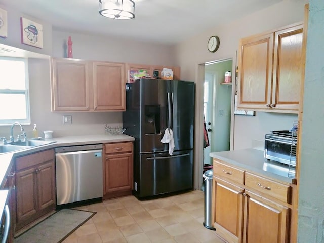 kitchen with light brown cabinetry, black fridge with ice dispenser, stainless steel dishwasher, and sink