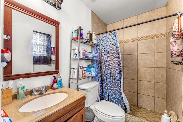 bathroom with vanity, toilet, and curtained shower