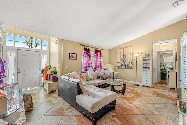 living room featuring tile patterned flooring, lofted ceiling, and a notable chandelier