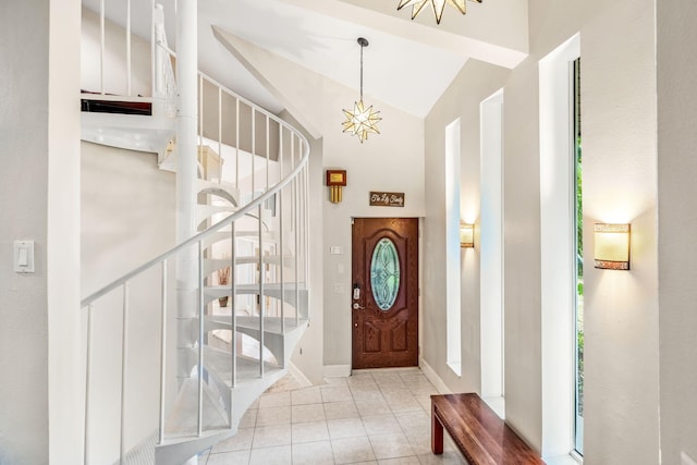 entryway featuring lofted ceiling, light tile patterned floors, a notable chandelier, and plenty of natural light