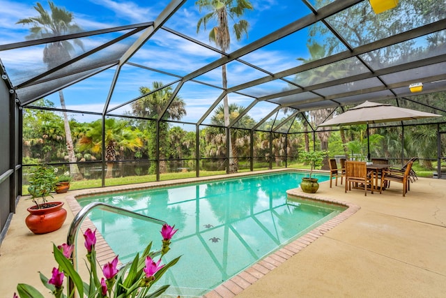 view of swimming pool featuring a patio area and glass enclosure