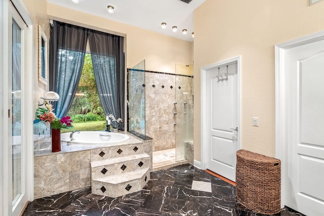 bathroom featuring separate shower and tub