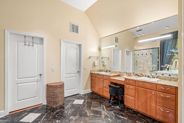 bathroom with lofted ceiling, vanity, and a shower with shower door