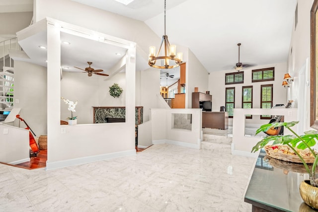 entrance foyer featuring lofted ceiling and ceiling fan with notable chandelier