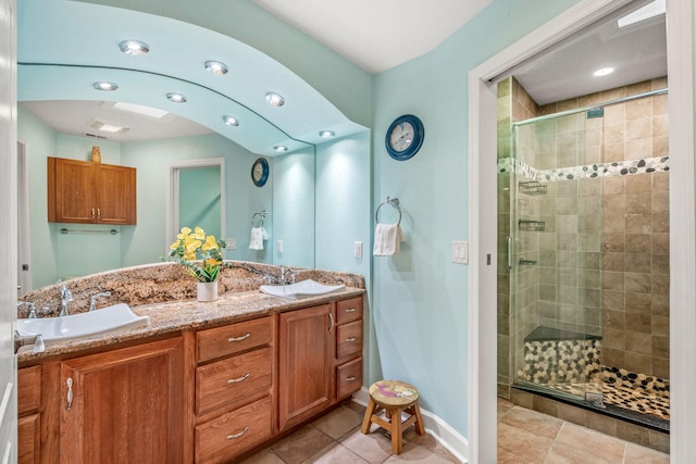 bathroom featuring vanity, tile patterned flooring, and a shower with shower door