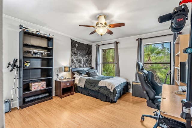 bedroom featuring wood-type flooring, ornamental molding, and ceiling fan