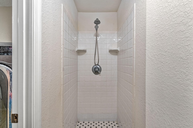 bathroom with tiled shower