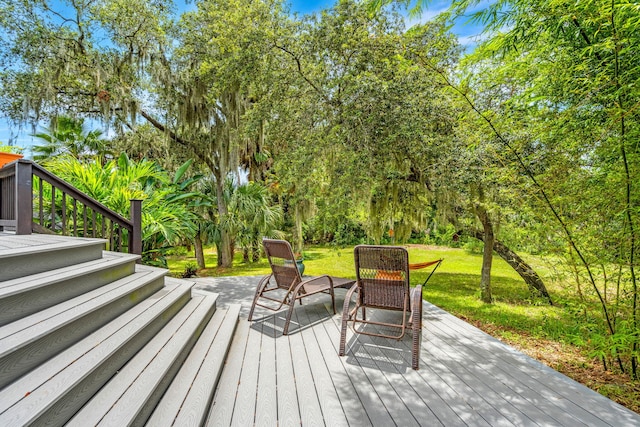 wooden terrace with a lawn