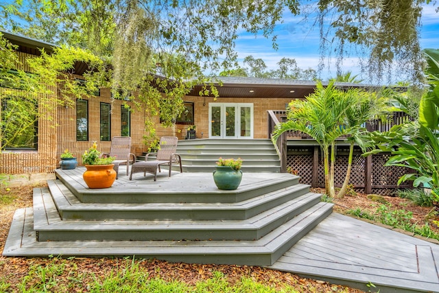 rear view of house featuring a wooden deck