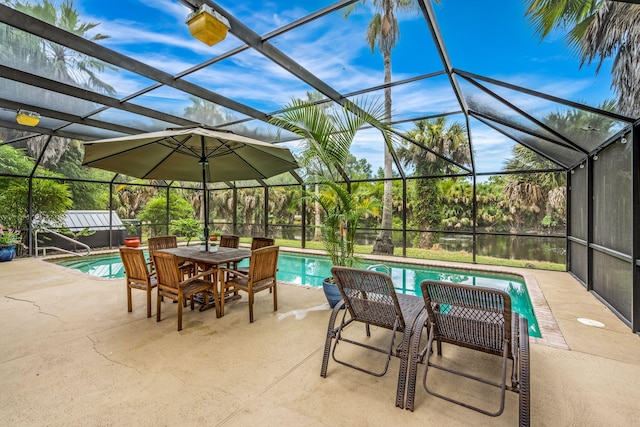 view of patio / terrace featuring a swimming pool with hot tub and a lanai