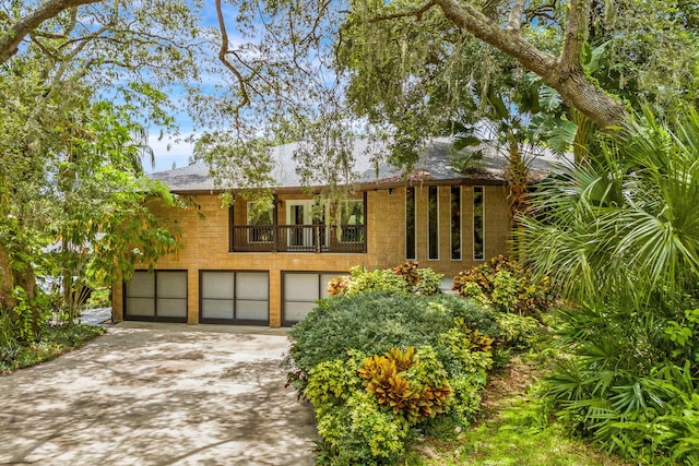 view of front of home featuring a garage and a balcony