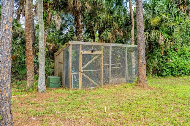 view of outbuilding with a yard