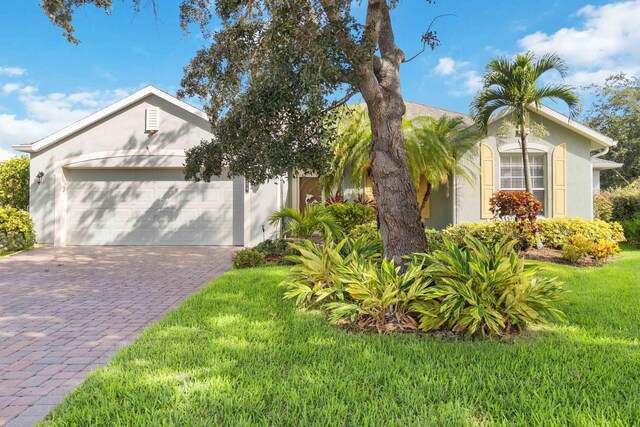 view of front facade with a garage and a front yard