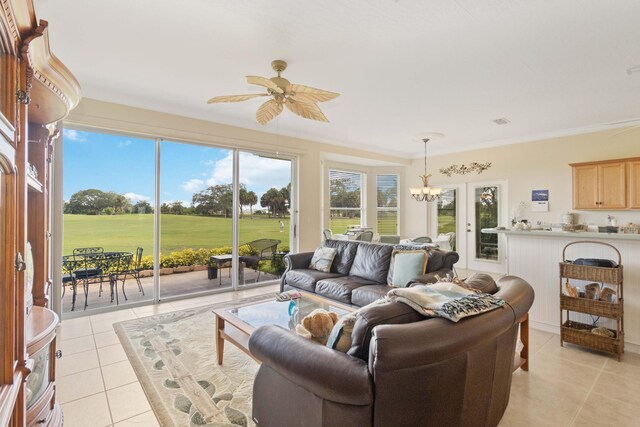 tiled living room featuring ceiling fan with notable chandelier and crown molding