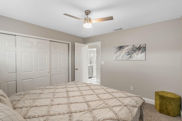 bedroom featuring sink, a closet, ceiling fan, and carpet flooring