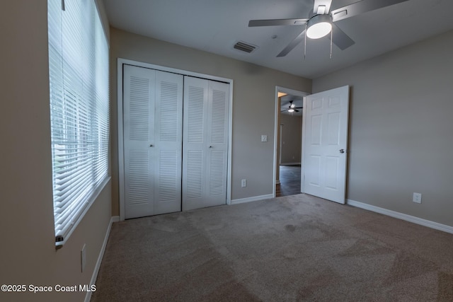 7667 N Wickham Rd Unit 1515, Melbourne, FL 32940 - unfurnished bedroom featuring carpet floors, a closet, baseboards, and a ceiling fan