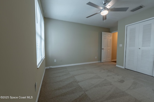 7667 N Wickham Rd Unit 1515, Melbourne, FL 32940 - unfurnished bedroom featuring a closet, baseboards, ceiling fan, and carpet flooring