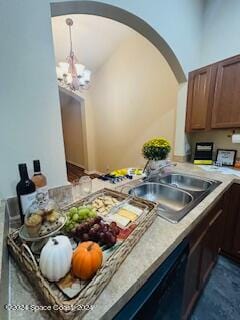 kitchen with sink and a chandelier