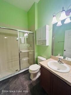 bathroom with vanity, a shower with shower door, and toilet