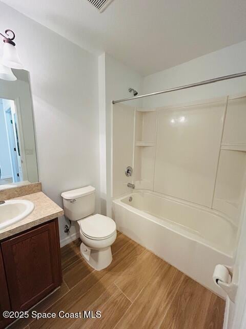 bathroom featuring vanity,  shower combination, toilet, and wood finished floors