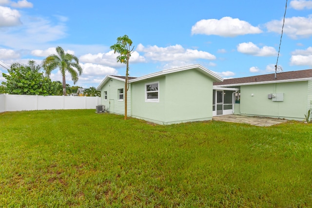 back of property featuring a yard, a patio, and central AC