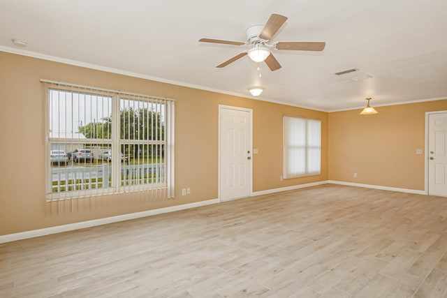 unfurnished room featuring light hardwood / wood-style floors, ornamental molding, and ceiling fan